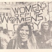 Photograph from newspaper of QMUL Womens Group marching at a protest with banners
